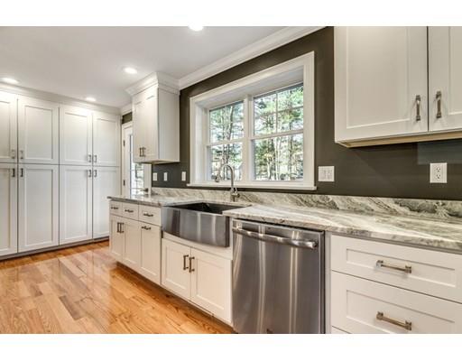 7 Tremlett Road Billerica, MA 01821 - Photo 8 of 30 a kitchen with stainless steel appliances granite countertop a stove a sink and a white cabinets with wooden floor