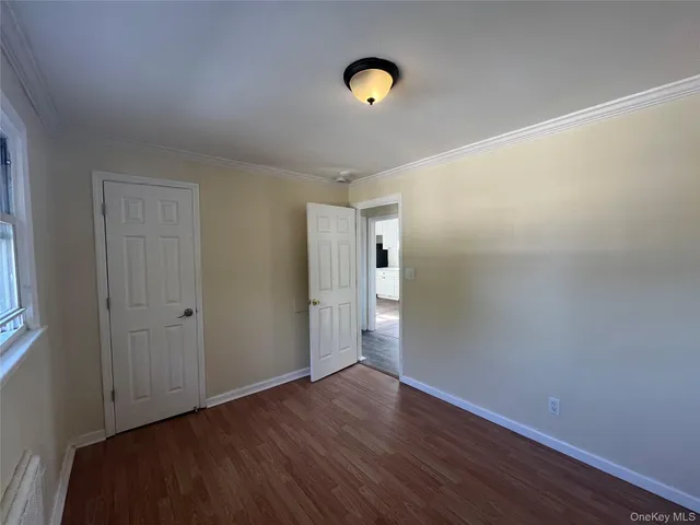 a view of a room with wooden floor and window