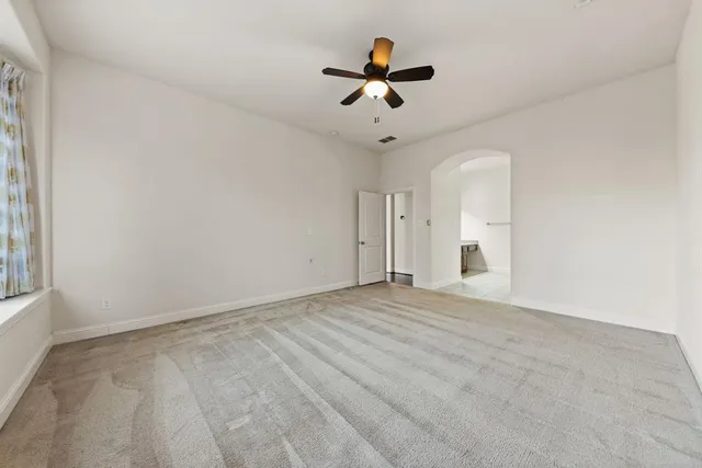 a view of empty room with ceiling fan