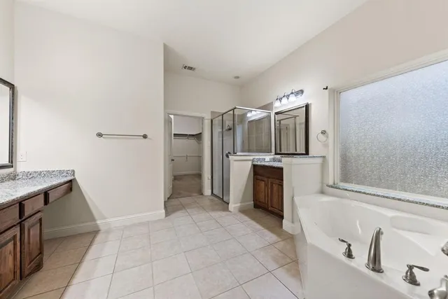 a kitchen with granite countertop a refrigerator and a stove top oven