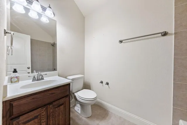 a bathroom with a toilet a sink and mirror