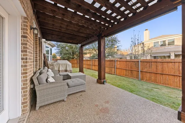 a view of a patio with couches chairs and wooden floor