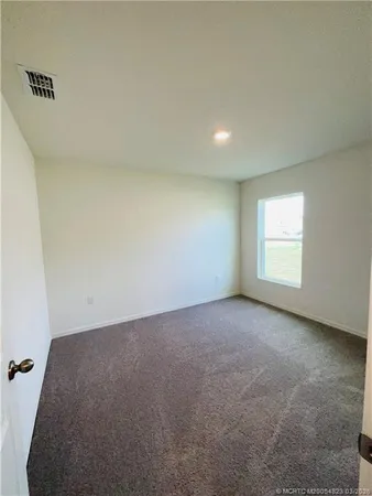 a view of an empty room and a window