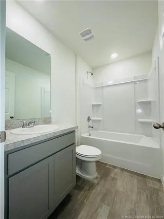 a bathroom with a toilet a sink and bathtub