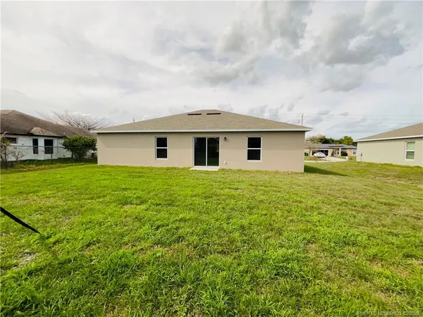 a view of a house with yard and sitting area