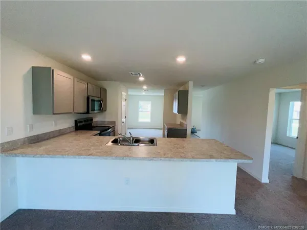 a dining hall with couches and cabinets