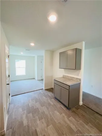 a room with a stove and cabinets
