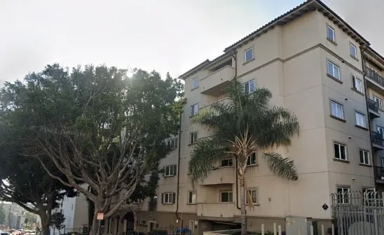 a view of multiple house with a tree