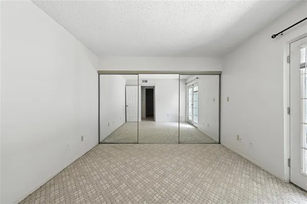 a view of an empty room with glass door