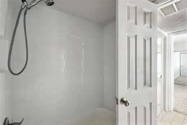 a bathroom with a bath tub with a shower