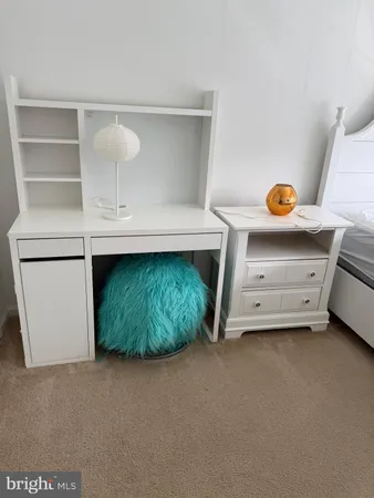 a bedroom with a bed and a night stand