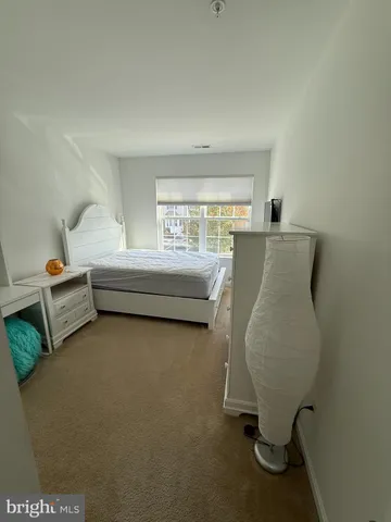a bedroom with a bed and flat screen tv