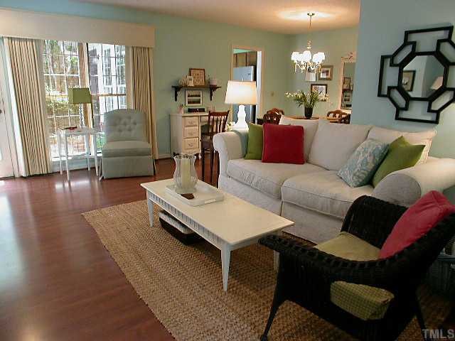 6902 Saxby Court Raleigh, NC 27613 - Photo 4 of 12 Open and bright the two windows and door. Laminate flooring. Window treatments remain.