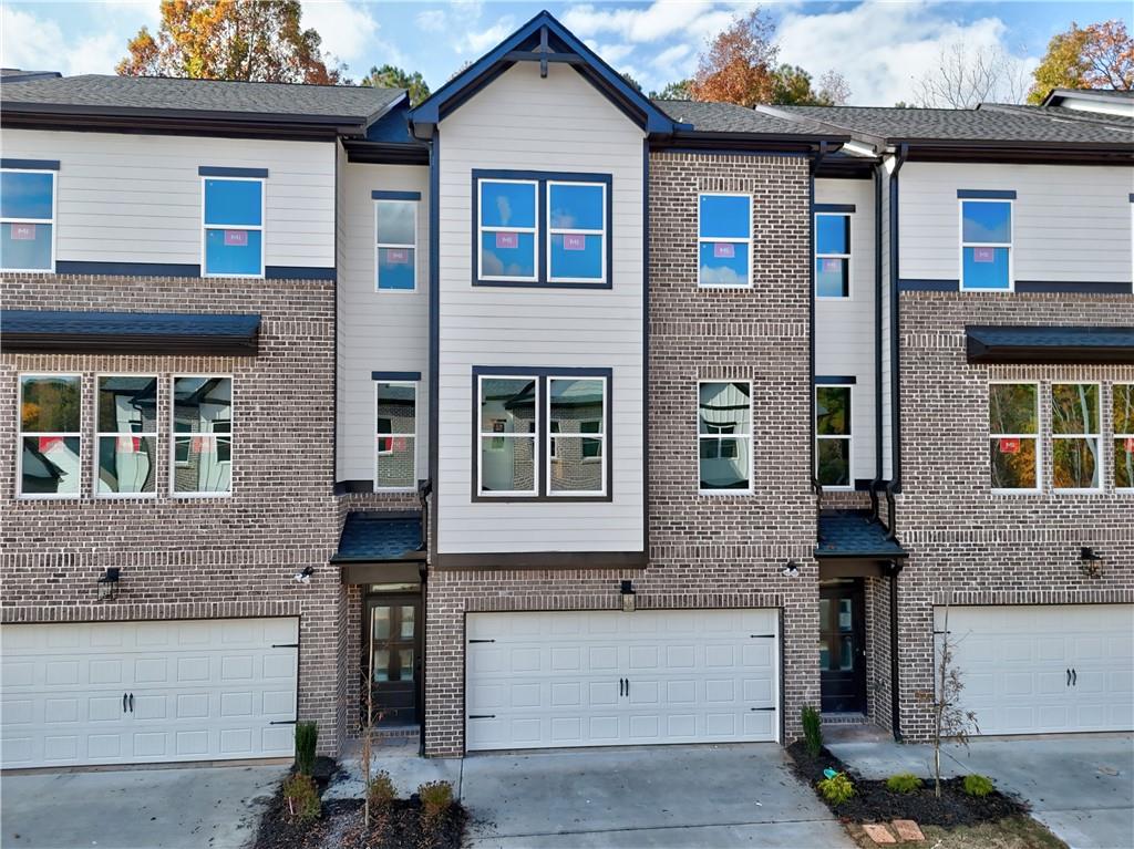24 Rock Pk Way, Unit 21 Tucker, GA 30084 - Photo 1 of 4 a front view of a house with a yard