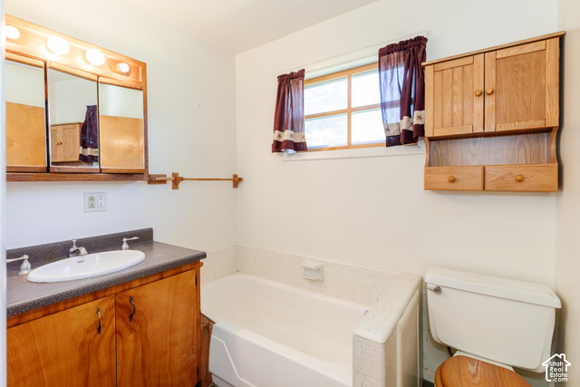 3959 Main Street Logan, UT 84321 - Photo 22 of 35 Built-in bathtub, wood-finish vanity with integrated sink, wood-finish medicine cabinet, wood-finish wall-mounted storage, and a single window