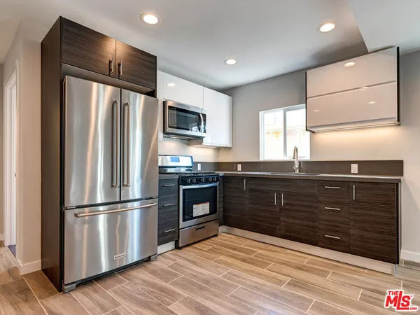 a kitchen with a refrigerator stove and sink
