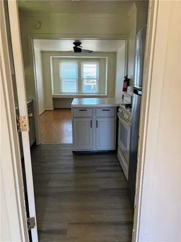 a view of kitchen with granite countertop window