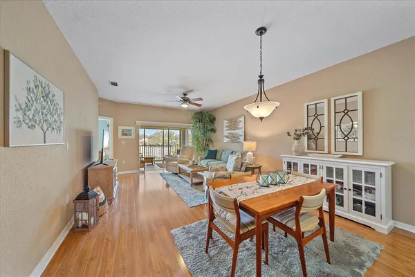 a living room with furniture a window and wooden floor
