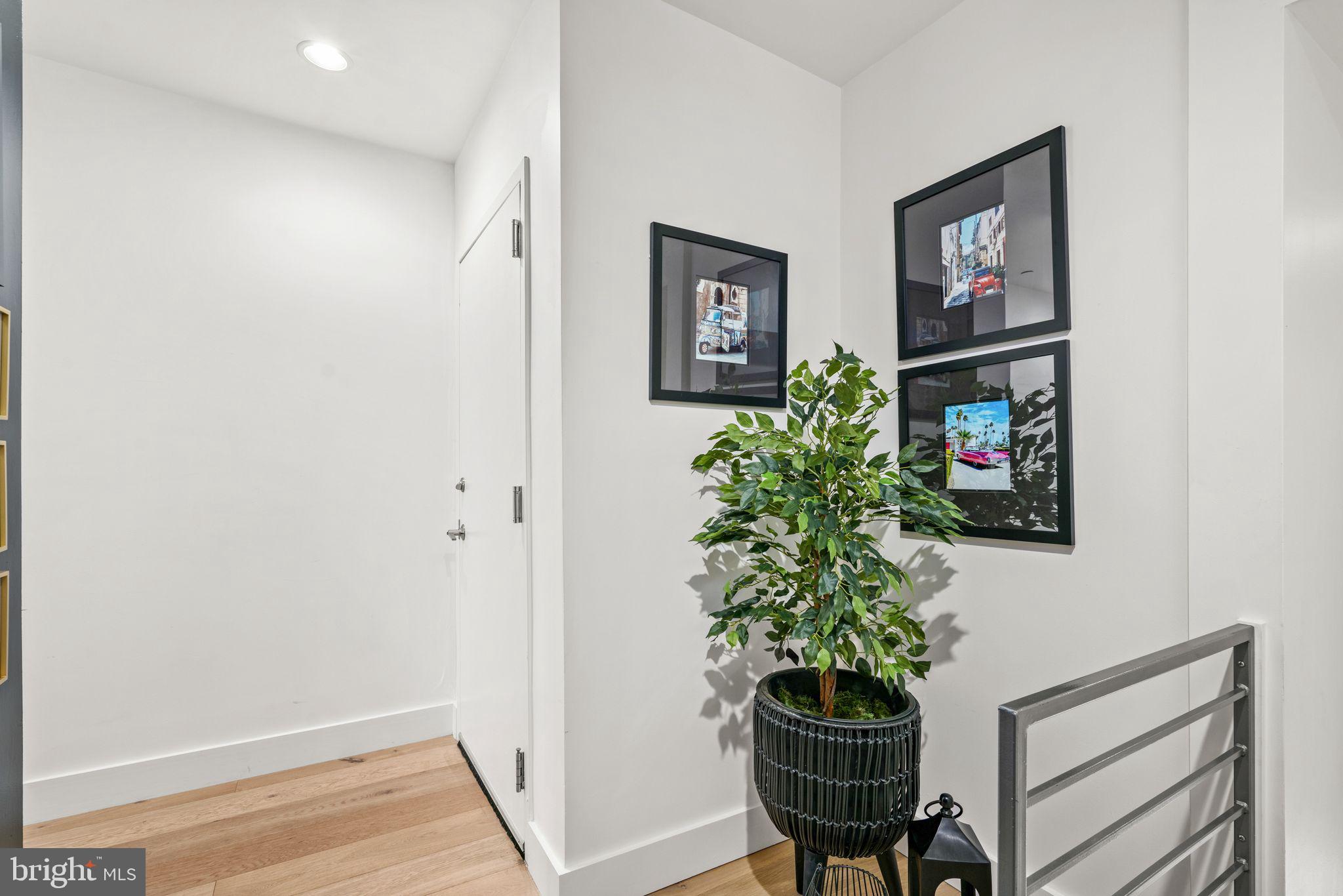 1606 Chestnut Street, Unit 4 Philadelphia, PA 19103 - Photo 24 of 35 a view of a hallway with wooden floor and a potted plant