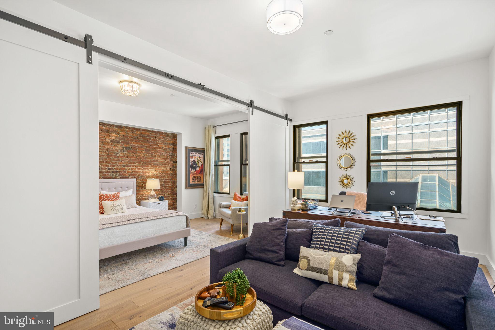 1606 Chestnut Street, Unit 4 Philadelphia, PA 19103 - Photo 29 of 35 a living room with furniture and a large window