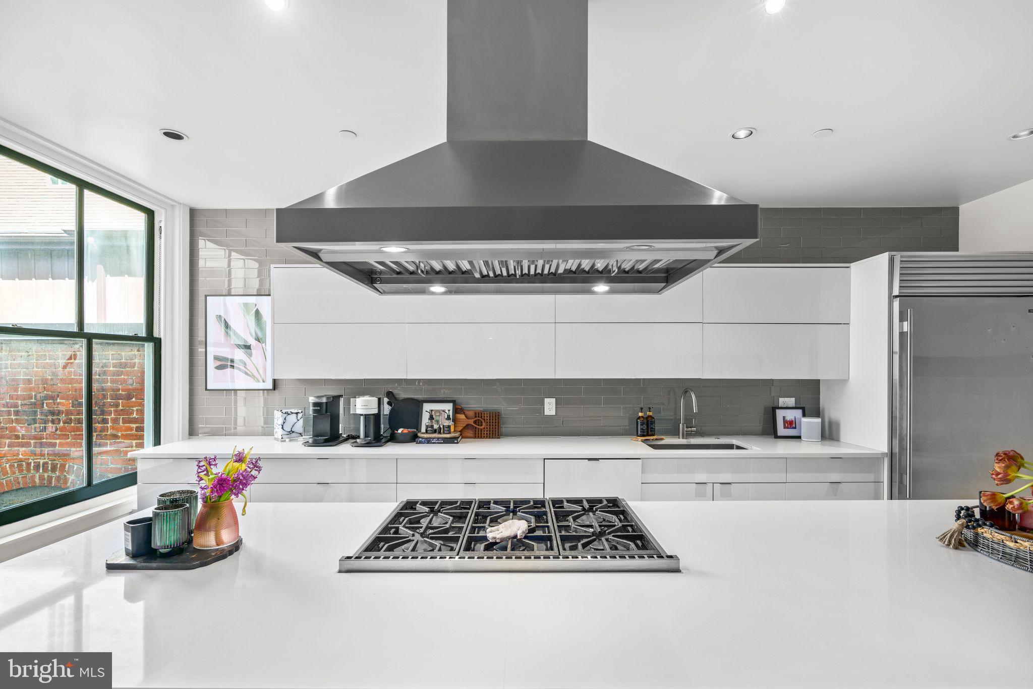 1606 Chestnut Street, Unit 4 Philadelphia, PA 19103 - Photo 4 of 35 a kitchen with stainless steel appliances a stove and a refrigerator