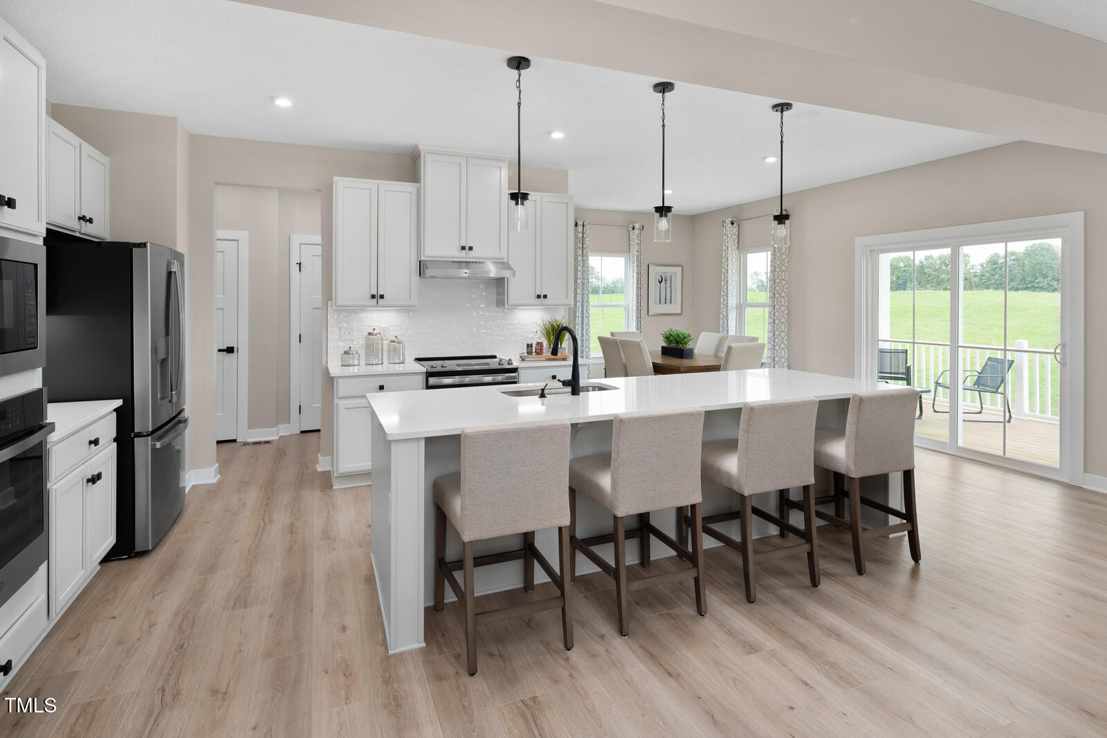 901 Walker Rdg Way Willow Spring, NC 27592 - Photo 3 of 30 a large kitchen with a table and chairs