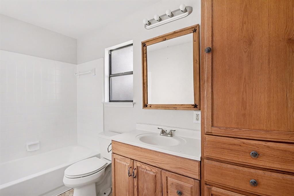 7912 Prairie Drive Watauga, TX 76148 - Photo 15 of 20 a bathroom with a sink a toilet and vanity