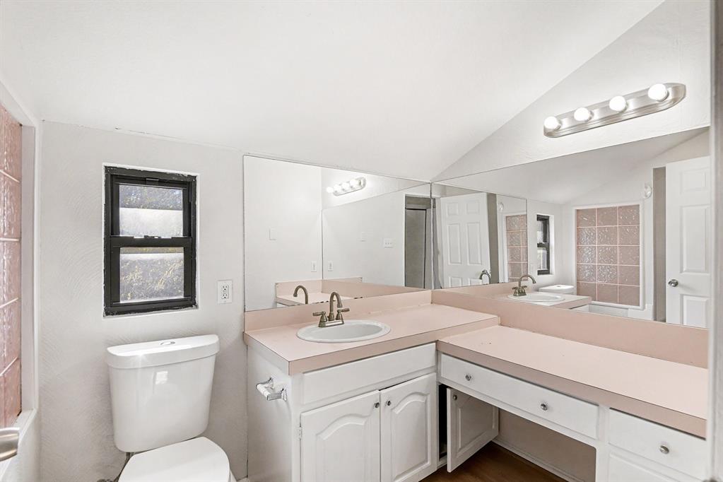 7912 Prairie Drive Watauga, TX 76148 - Photo 16 of 20 a bathroom with a toilet sink and mirror