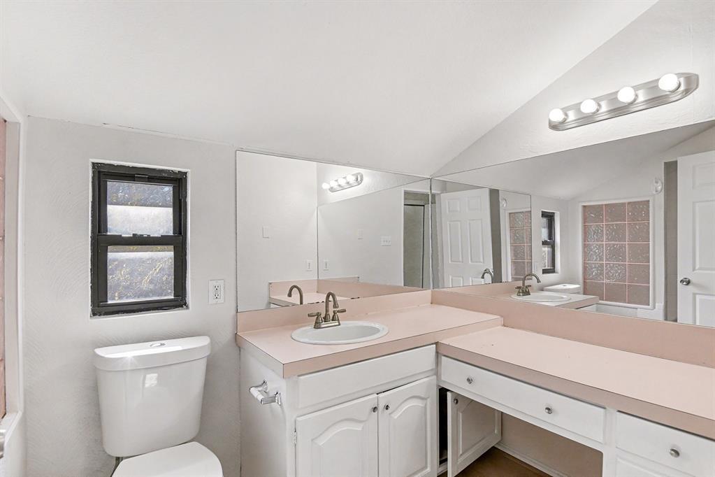 7912 Prairie Drive Watauga, TX 76148 - Photo 19 of 20 a bathroom with a toilet sink and mirror