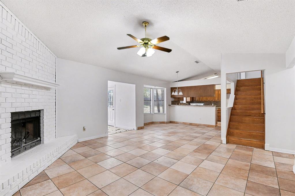 7912 Prairie Drive Watauga, TX 76148 - Photo 3 of 20 a view of empty room with fireplace and fan