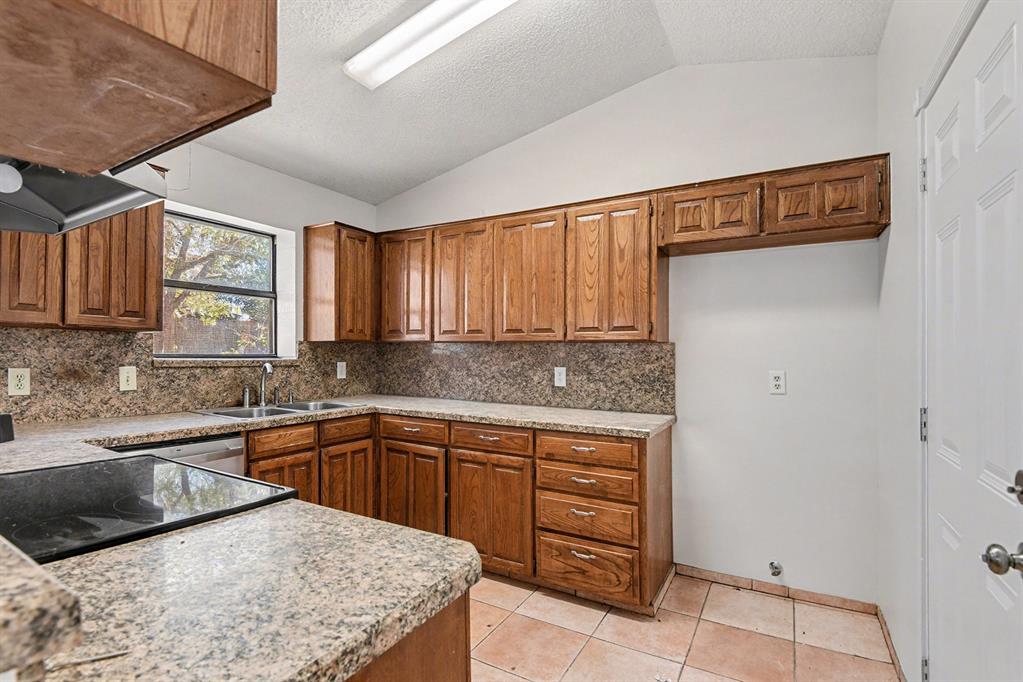 7912 Prairie Drive Watauga, TX 76148 - Photo 9 of 20 a kitchen with a sink a stove and cabinets