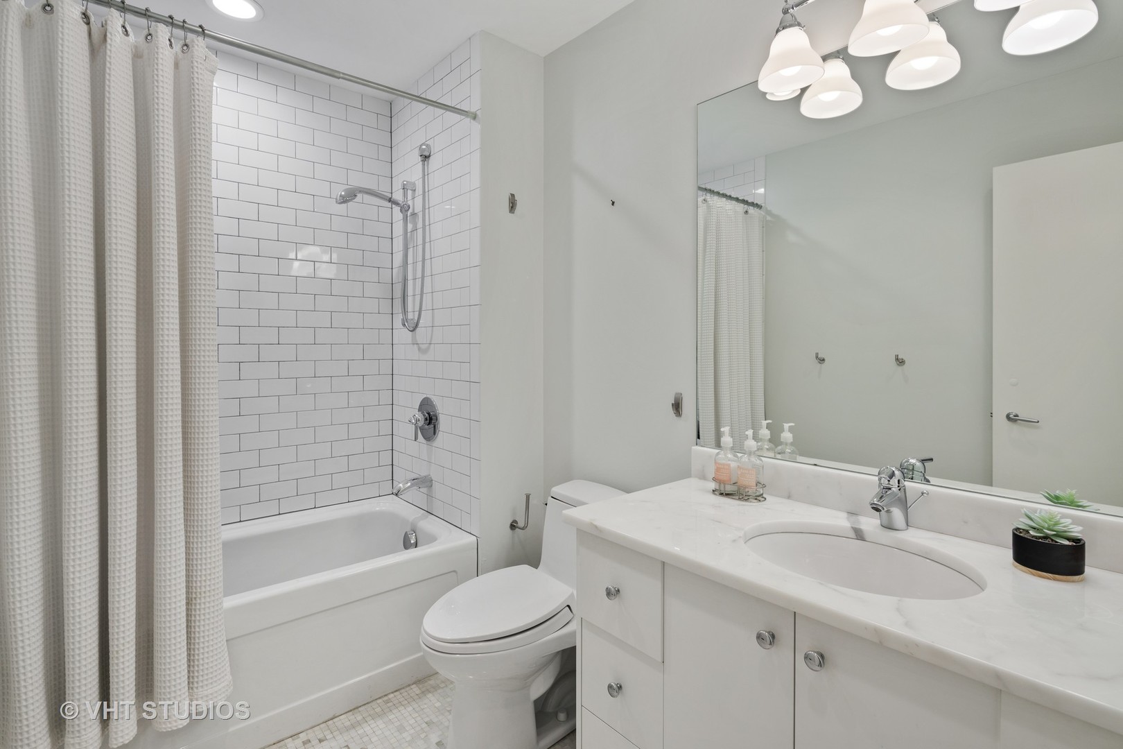 2673 North Greenview Avenue, Unit F Chicago, IL 60614 - Photo 15 of 23 a bathroom with a sink a toilet and shower