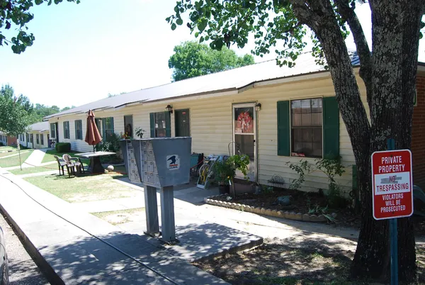 a front view of a house with yard garage and furniture