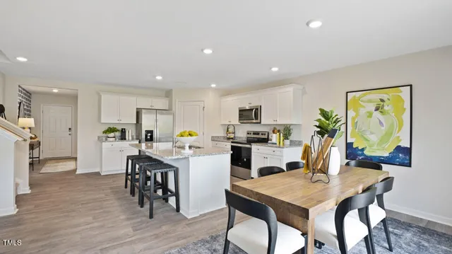 a view of kitchen with cabinets table and chairs
