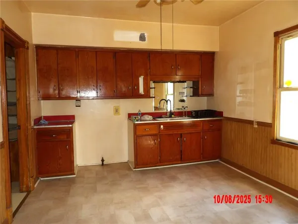 a kitchen with granite countertop a sink a stove and cabinets