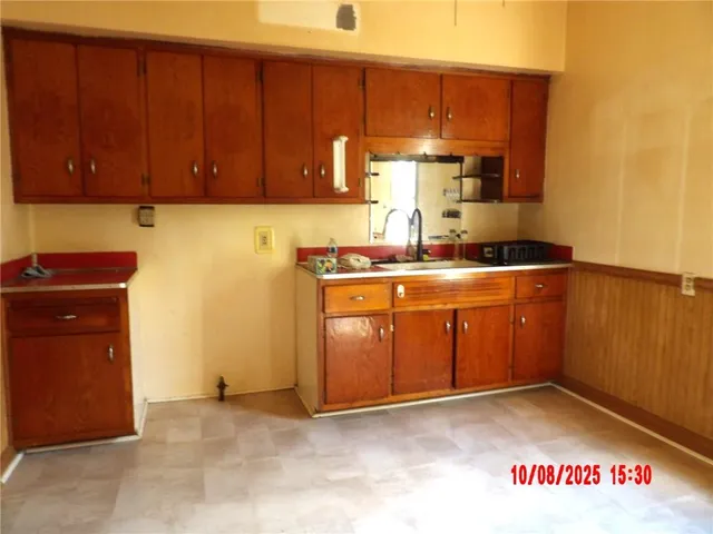 a kitchen with a stove top oven sink and cabinets