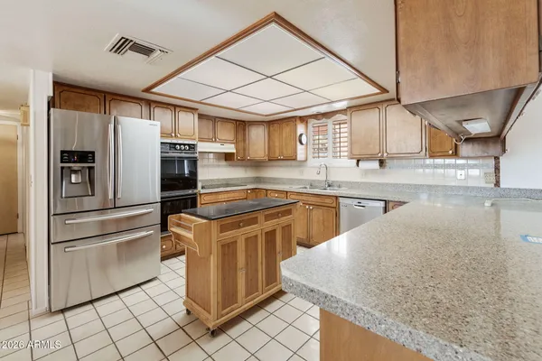 a kitchen with stainless steel appliances granite countertop a sink and cabinets