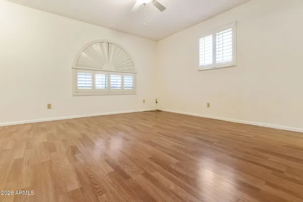 a bathroom with a toilet sink vanity and mirror