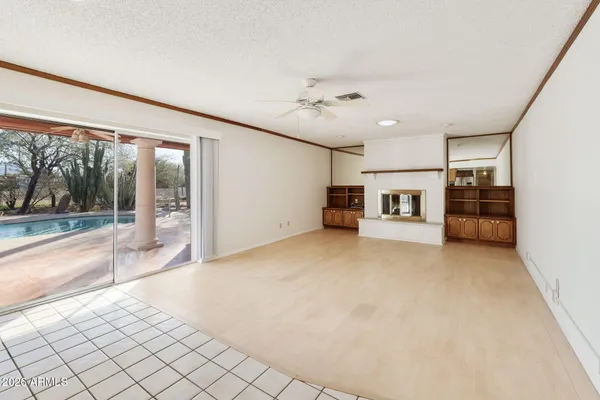 a living room with furniture and a floor to ceiling window