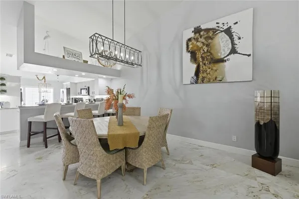 a living room with stainless steel appliances furniture a fireplace and a flat screen tv