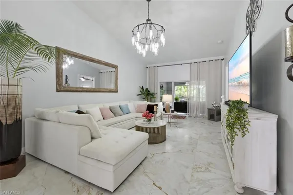 a living room with furniture and a chandelier