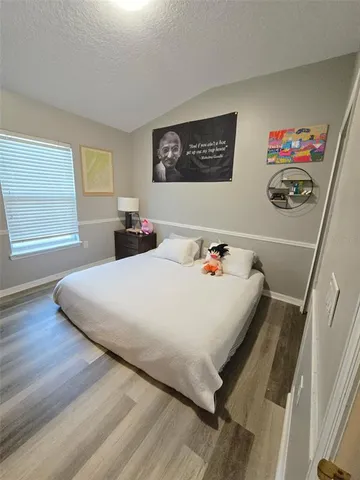 a bedroom with bed and a window