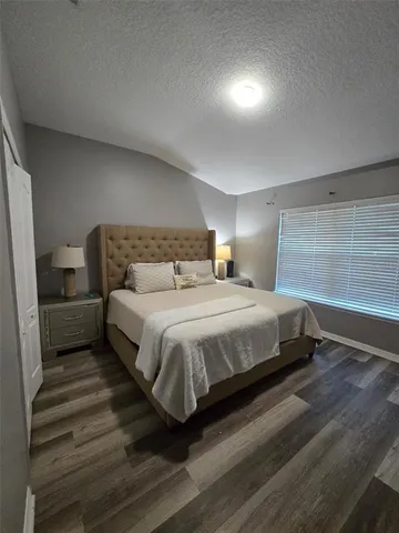 a bedroom with a bed and a couch