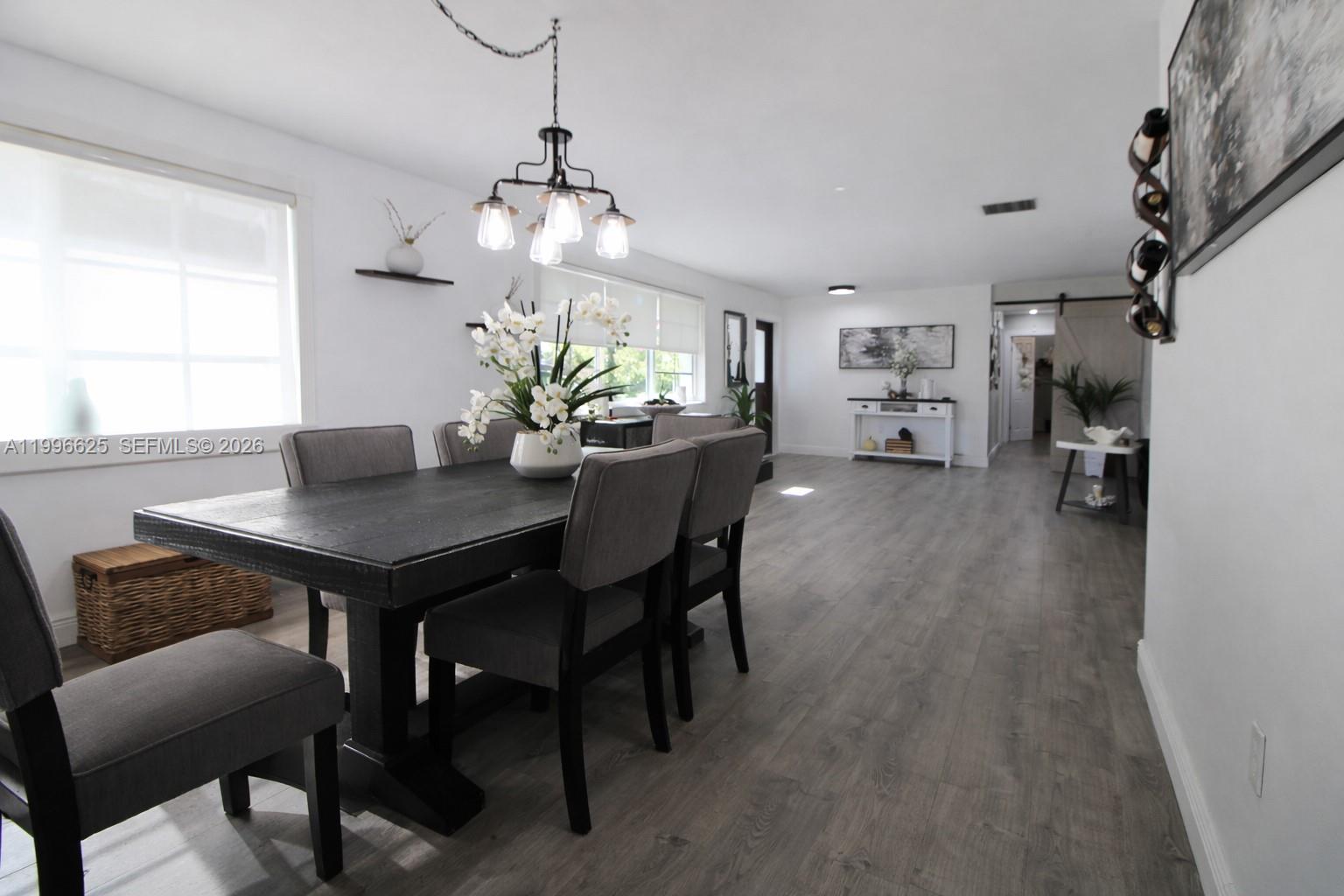 27420 Southwest 165th Avenue Homestead, FL 33031 - Photo 12 of 35 a view of a dining room with furniture and chandelier