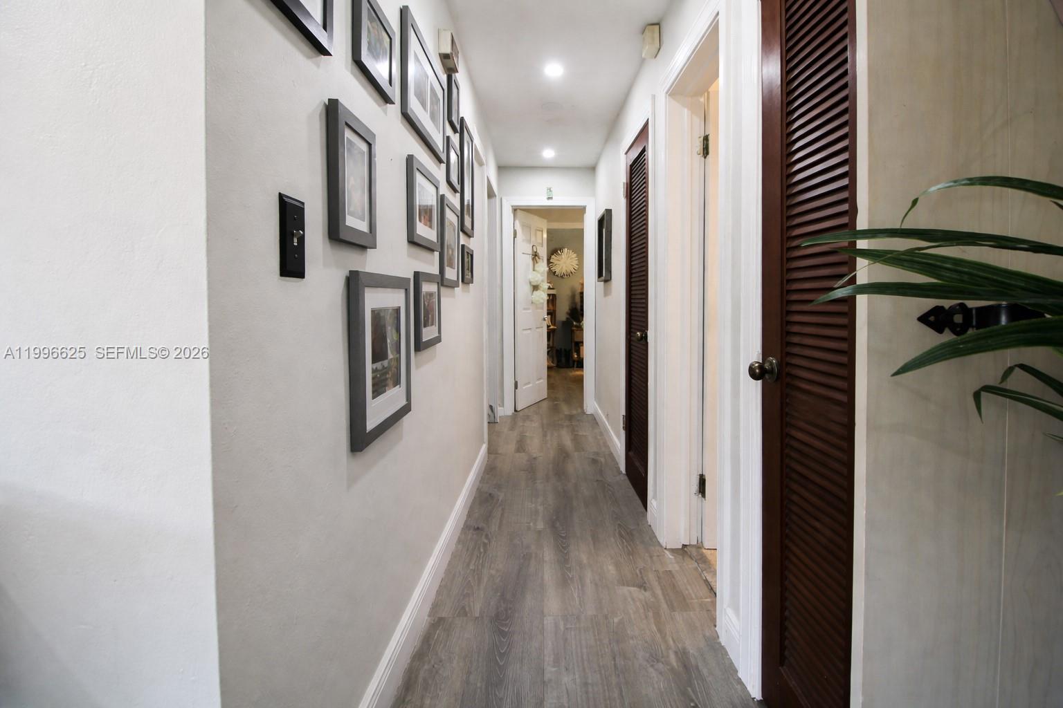 27420 Southwest 165th Avenue Homestead, FL 33031 - Photo 13 of 35 a view of a hallway with wooden floor and staircase