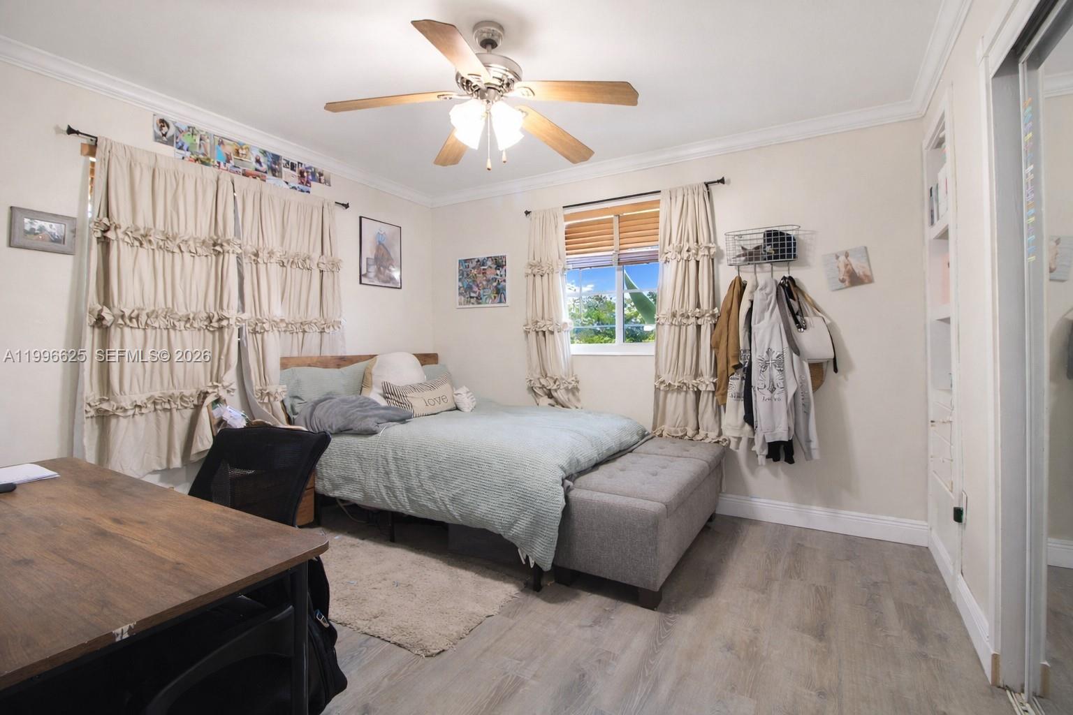 27420 Southwest 165th Avenue Homestead, FL 33031 - Photo 14 of 35 a spacious bedroom with a bed and a chandelier