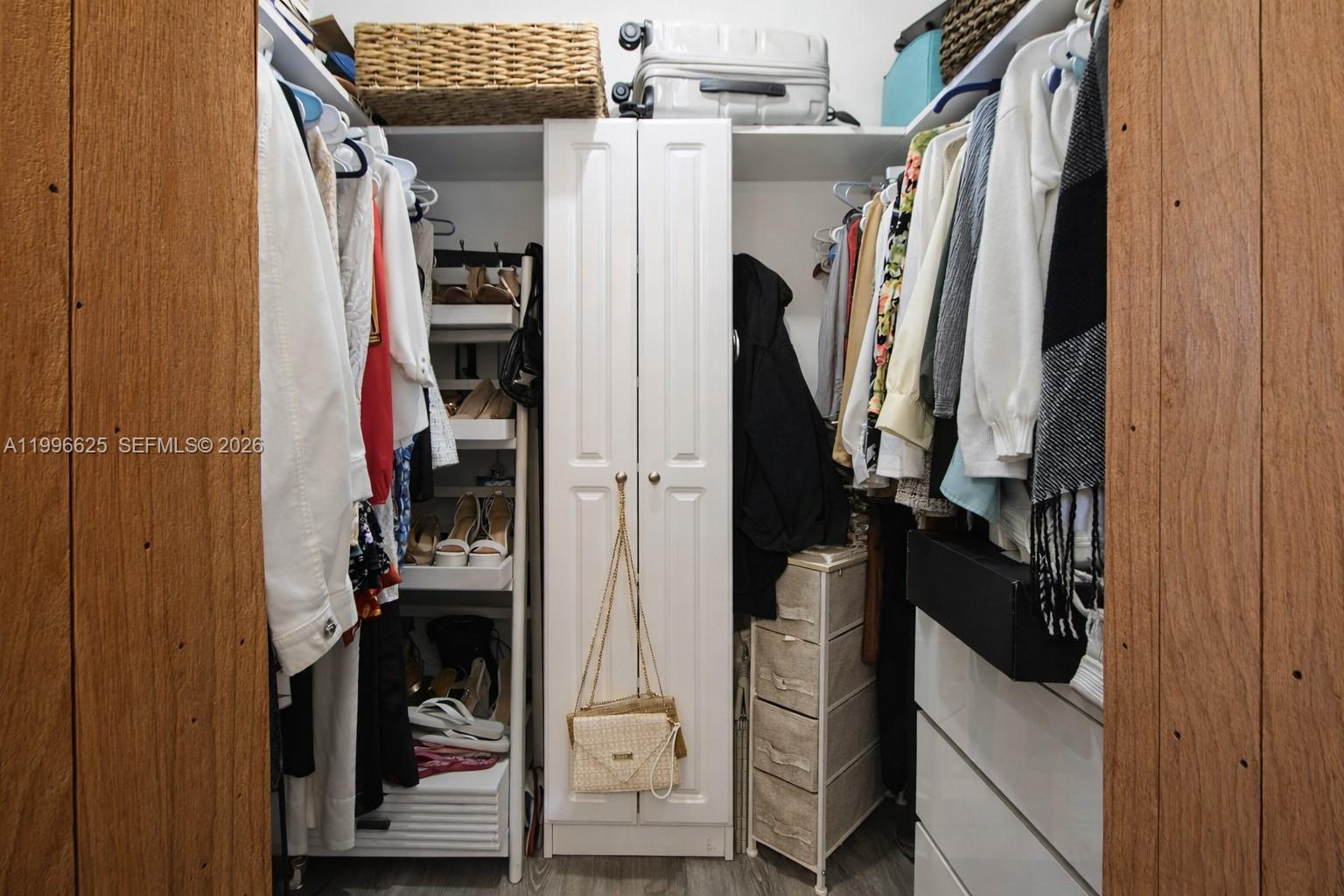 27420 Southwest 165th Avenue Homestead, FL 33031 - Photo 17 of 35 a view of walk in closet with clothes and shoes