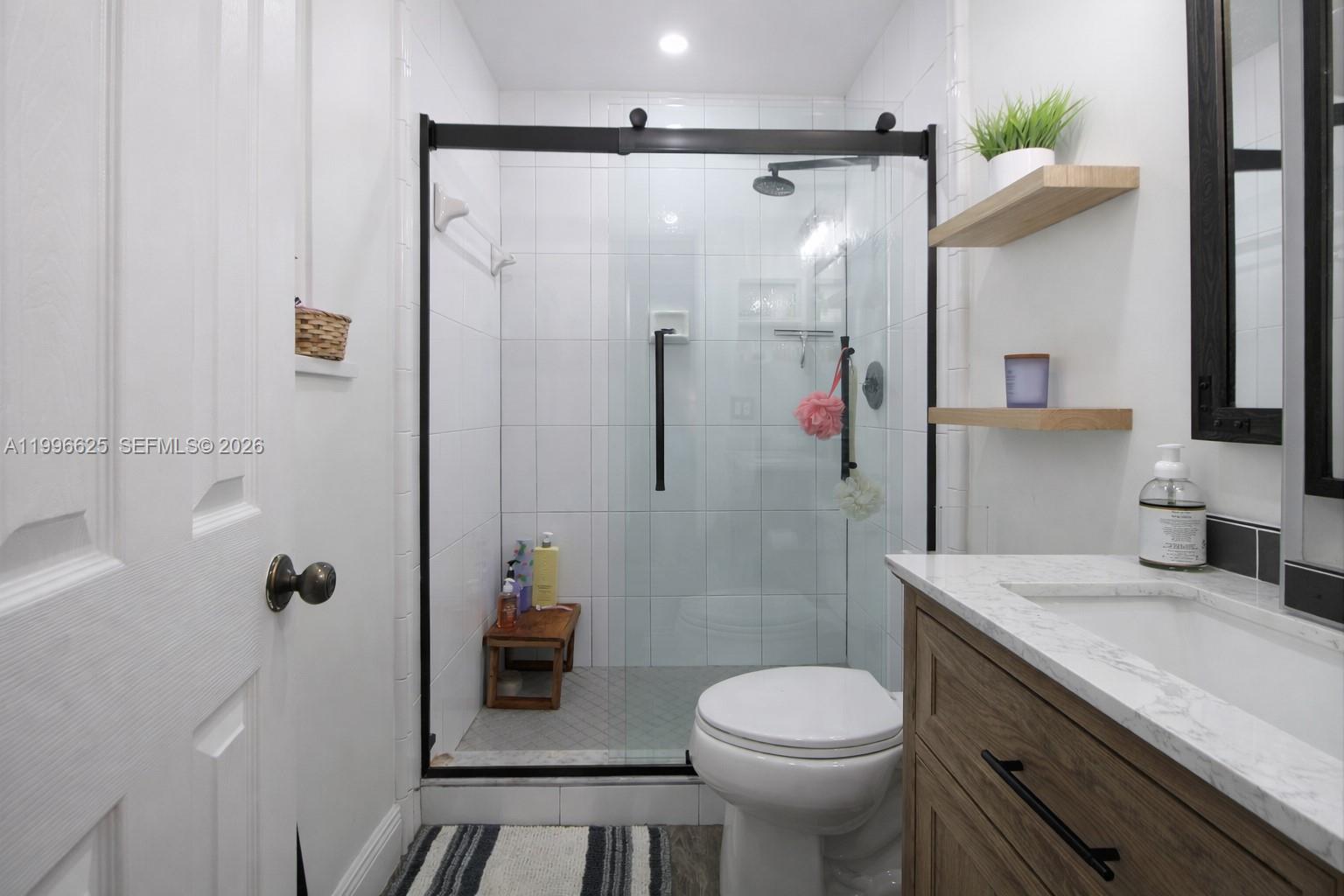 27420 Southwest 165th Avenue Homestead, FL 33031 - Photo 18 of 35 a bathroom with a sink a toilet and shower