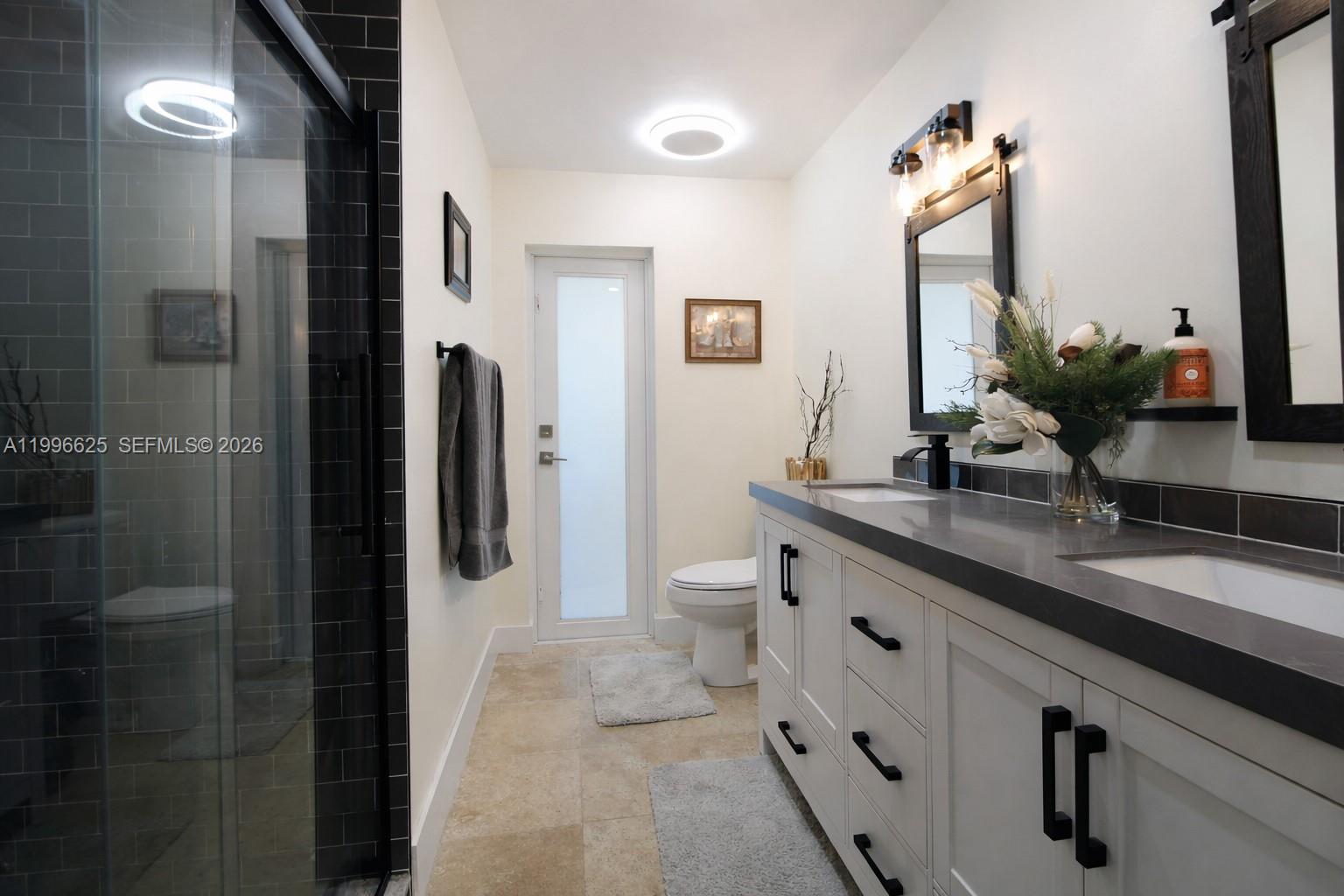 27420 Southwest 165th Avenue Homestead, FL 33031 - Photo 20 of 35 a spacious bathroom with a granite countertop sink and a mirror