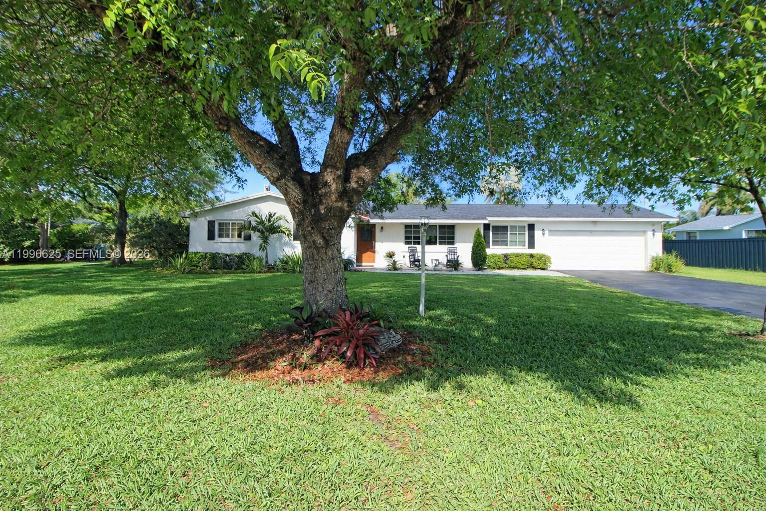 27420 Southwest 165th Avenue Homestead, FL 33031 - Photo 2 of 35 a house view with a garden space
